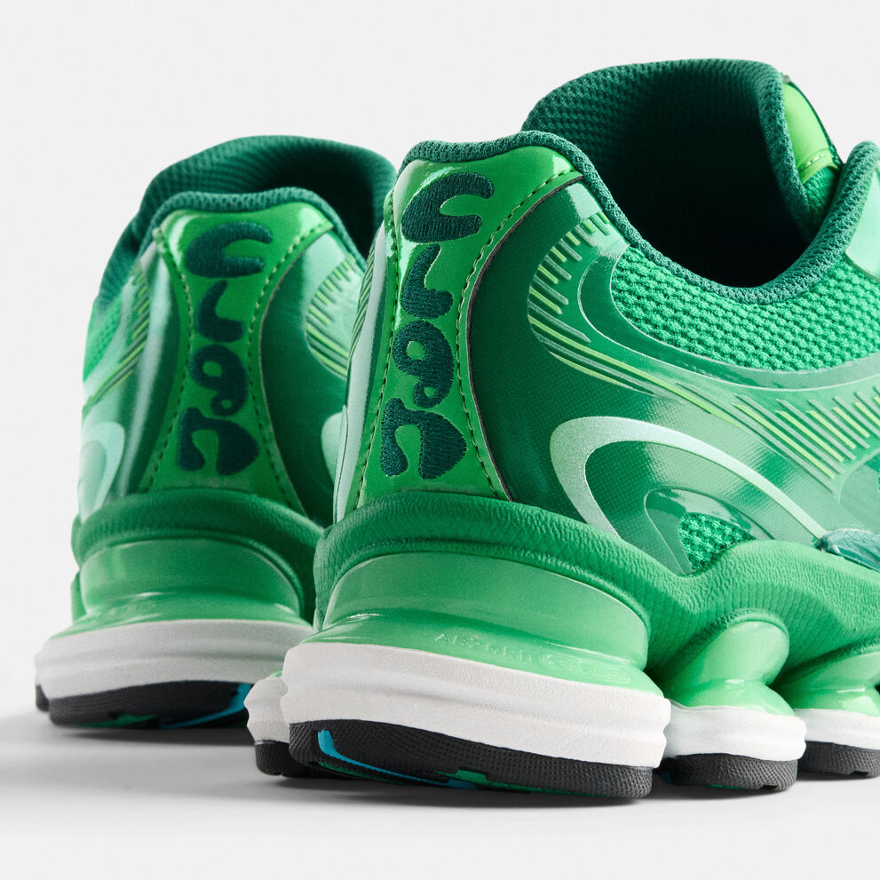 A woman standing against a barn backdrop. 