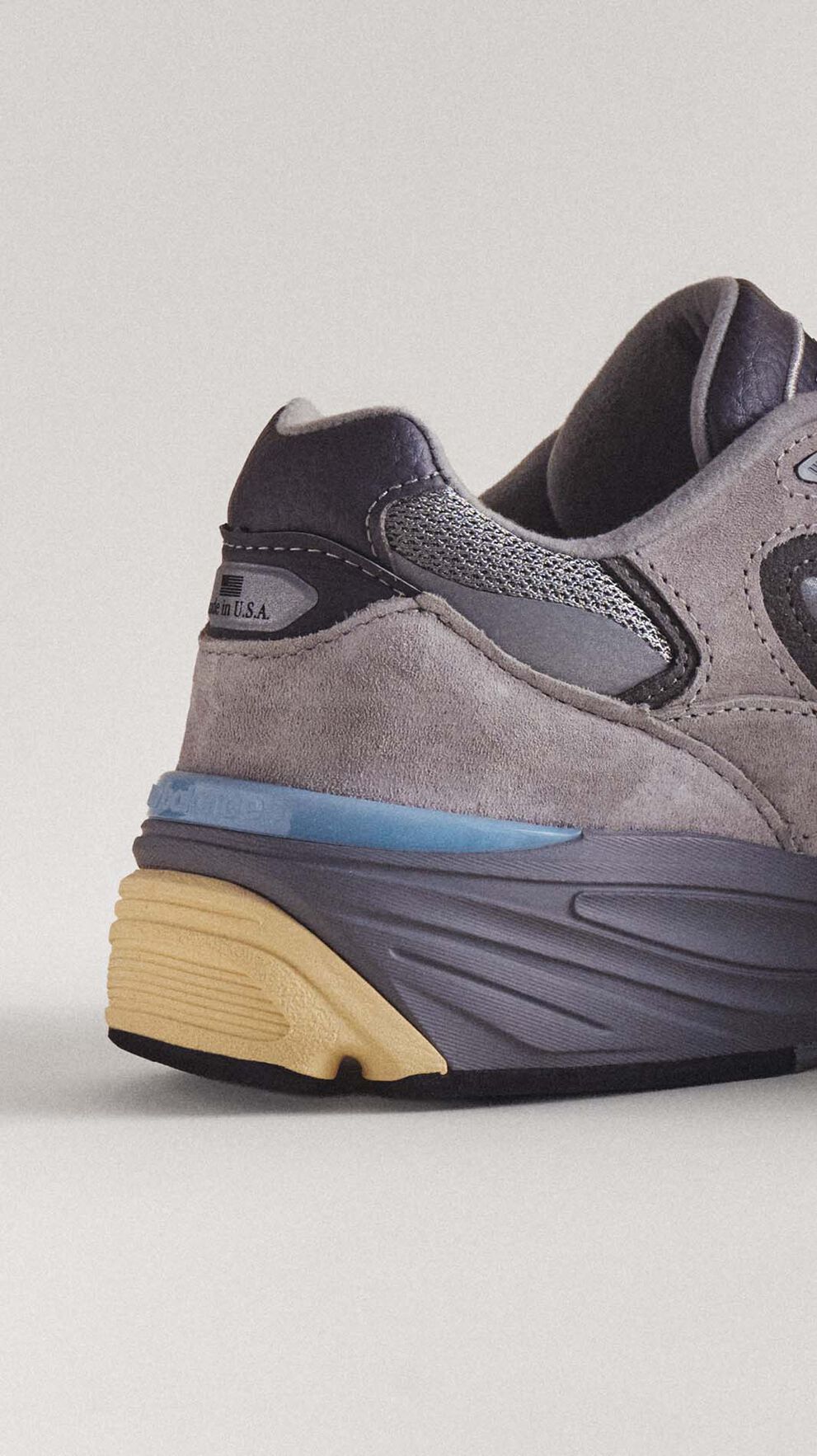 A close-up of the heel of a grey 990v7 sneaker