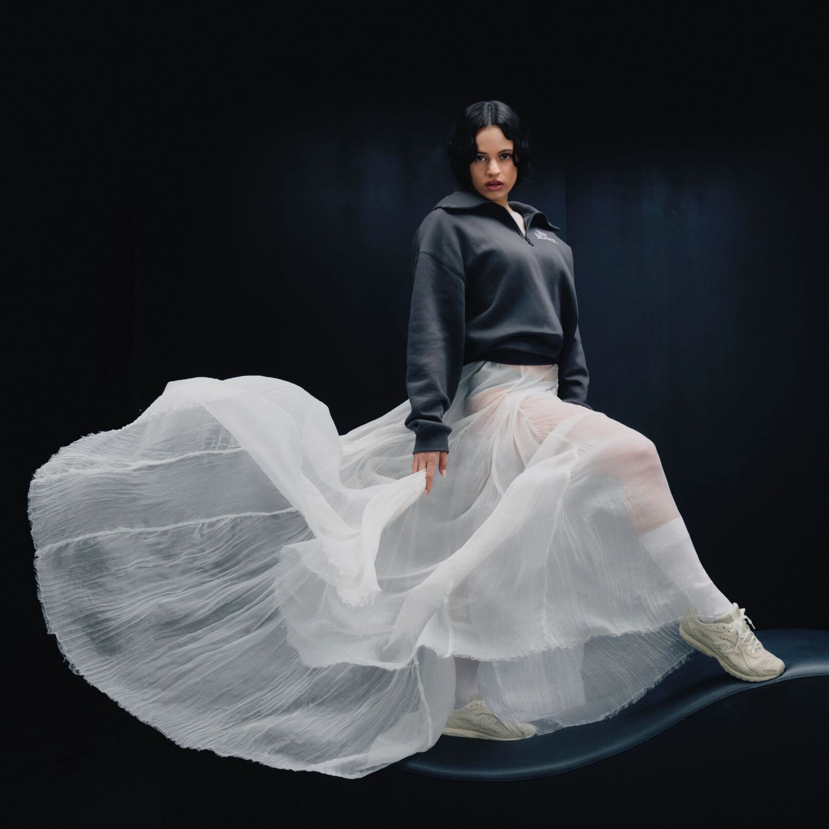 Rosal&iacute;a kneeling on a white studio backdrop