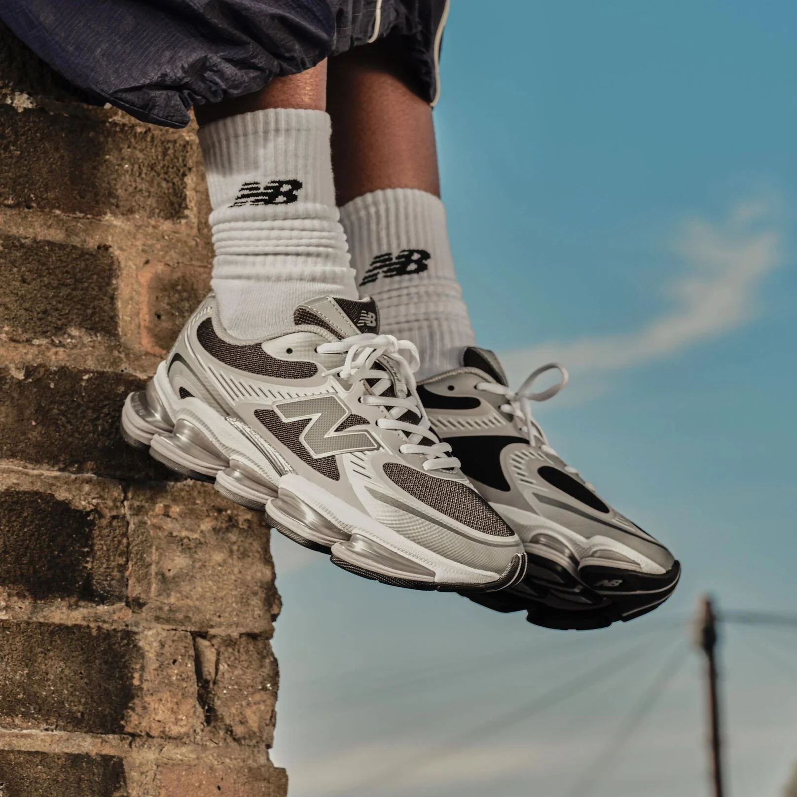A woman standing against a barn backdrop. 