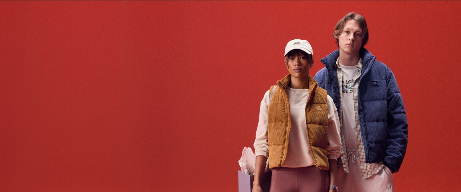 A couple against a red background